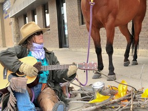 Janet Watmough of the Pincher Creek Ag society is joined by CD as they busk on Main Street promoting the Cowboy Gathering last summer. The name has changed, but the same images can be expected this year at the Best of the West weekend. Bryan Passifiume photo/QMI Agency.
