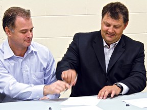 Island Falls Forestry signed a 20-year agreement Wednesday to supply harvested wood for Cochrane-based True North Hardwood Plywood Inc. Signing the Woodlands Administration Services Agreement are Raymond Poe, COO of True North and Mark Massicotte, IFF general manager.