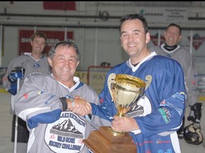 Wild Rose MP Blake Richards presents the Wild Rose Cup to form Detroit Red Wing Dennis Polonich.