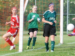 Quinte West U13 Wolverines KaitlynSpagnolo and Holly Tetzlaff try to prevent a Belleville Comet from scoring during Southeast Ontario Soccer Association play last Wednesday at Centennial Park. The Wolverines dropped a 4-0 decision to the Comets.