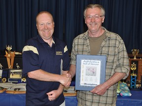 John Van Allen accepts the Norwood District High School Athletic Hall of Honour award on behalf of his son, Ken Van Allen, from athletics director and coach Todd Murray last week during the school's 2012-2013 Athletic Year-end Celebration.