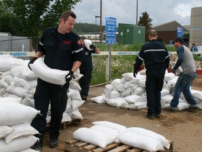 Volunteers gathered outside the Syncrude Sport and Wellness Centre Wednesday afternoon, getting down to work packing sandbags for residents to pickup and use to protect against rising water levels.