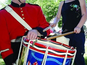 Fort Henry guard Sean Donaldson shows Rideau Heights Public School Grade 1 student Sabrina Revelle how to play the drum during the 2012 First Capital Day celebrations in Confederation Basin. This year, the City of Kingston is celebrating First Capital Day on June 14, inviting students and the public to get a taste of the 1800s.