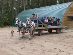 Parents and kids enjoyed a ride on the horse-drawn wagon Saturday at the Torch Trail Bible Camp Pool Kickoff.