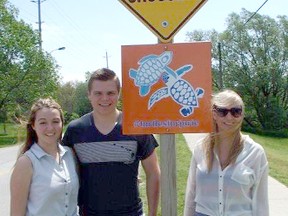 L-R: Carly Smith, Jarrett Elliot and Kloe Moore helped raise the new sign on May 31, 2013. (SUBMITTED)