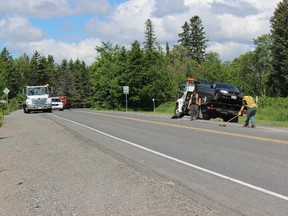 Ryen Veldhuis/For The Sudbury Star/QMI Agency. Workers clean up at the site of a three-vehicle collision on Regional Road 15 in Azilda on Thursday, June 13, 2013.