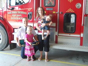 Nick Dorken stands with his wife Kim, and children Georgia, 4, and Tessa, 1, after recieving the prestigious Carnegie medal. Dorken rescued a man from a burning car while on vacation in Florida in February 2012. TARA BOWIE / SENTINEL-REVIEW / QMI AGENCY