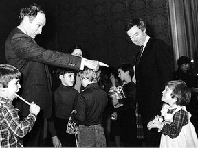 SUBMITTED PHOTO     Prime minister Pierre Trudeau (left) and opposition leader Joe Clark share a warm moment at a House of Commons kids Christmas party. Despite being political foes, Trudeau is said to have greatly respected Clark, the only man beat him in a federal election.