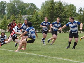 The Bruce County Rugby Football Club (RFC) marked the opening of its new field at the Tiverton Sports Centre on June 8, 2013. Head coach and player Jason Liddle faces his opponents head on. (ALANNA RICE/KINCARDINE NEWS)