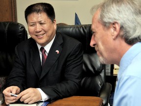 Mr. Meng Shengxi, chairman and senior economist for Zhejiang Hexin Investments and Management Co., laughs about a Tim Hortons story with Chatham-Kent Mayor Randy Hope, right, during a meeting with a number of delegates from China in Chatham to look at investment opportunities. PHOTO TAKEN Chatham, On., Thursday June 13, 2013 DIANA MARTIN/ THE CHATHAM DAILY NEWS/ QMI AGENCY