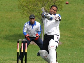 Batsman Avinhas Sinha makes contact with the ball while Devendera Saindane serves as keeper during a match at the opening of the new Grande Prairie Cricket Association pitch in Northridge Park last Saturday. The first of the GPCA Champions Trophy matches begins Sunday at 3 p.m. (Diana Rinne/Daily Herald-Tribune)