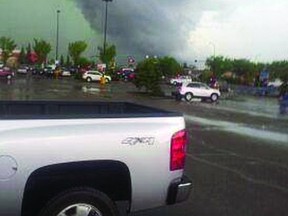 What might have been a funnel cloud is spotted from the southern Wal-Mart parking lot in Sherwood Park. “Some lady started yelling ‘That’s a funnel cloud, you need to get inside,’ ” recalled Kelli Pardo, whose mother took the above photograph. Photo Courtesy Cheri Weder