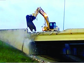 Demolition crews work to take down the eastbound Baseline Road bridge over the Anthony Henday (Highway 216) last month. Photo Supplied