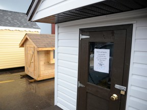 Due to poor weather conditions, the Pregnant and Parenting Teens Program's annual playhouse raffle is held inside the Walmart on 100 Ave, while the five playhouses built by Grande Prairie's Composite High School sit in parking lot puddles on Thursday, June 13, 2013. Excessive rain has slowed sales, and currently only 40% of tickets have been sold. The final draw is slated for June 28. CARYN CEOLIN/HERALD-TRIBUNE
