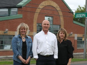 Nicki Diak (left), project manager for Home Base Housing, Tom Greening, executive director, and Colleen McAlister-Lacombe, project manager for emergency shelter Inn From The Cold, stand at the new location for the housing agency's services at 540 Montreal St. The building, at the corner with Joseph Street, has recently been purchased. 
Danielle VandenBrink/The Whig-Standard