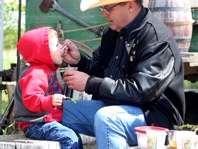 KASSIDY CHRISTENSEN HIGH RIVER TIMES. From left: Locke Nicholl samples some of the delicious stew all thanks to the help of his grandfather Joe Gore.