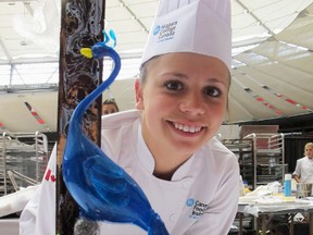 Megan Proper poses with and a sugar showpiece -- a showy blue peacock sculpture she named "Casanova of the Wild." (Submitted Photo)