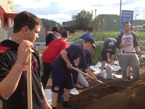 Members of the Fort McMurray Midget AAA Oil Giants baseball team helped out in flood mitigation efforts by filling sandbags at the Syncrude Sport and Wellness centre.