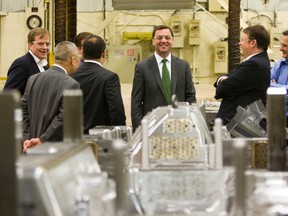 Conservative Leader Tim Hudak, second from right, tours Lamko Tool and Mold in London Thursday with Elgin-Middlesex-London MPP Jeff Yurek, left, Kan Lam, Rob Stewart, Ali Chahbar and Coun. Paul Van Meerbergen. (DEREK RUTTAN, The London Free Press)