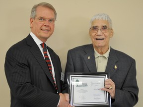 As one of his last duties, Community Foundation of Portage and District board chairman Barney Christianson presents a Builder's Certificate to Orille Hogue, who contributed $200,000 to the foundation in 2012 to create bursaries in his name and his late wife Gwen's name. (CLARISE KLASSEN/PORTAGE DAILY GRAPHIC/QMI AGENCY)