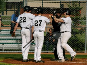 Whitesox player Josh Turner is greeted by teammates after he drilled a three-run homer over the left field fence at Singer Park in the 10-9 win over the Fort Saskatchewan A’s. Turner is on the DL as a pitcher but has been hitting at a .400 clip in his role as a DH. - Gord Montgomery, Reporter/Examiner