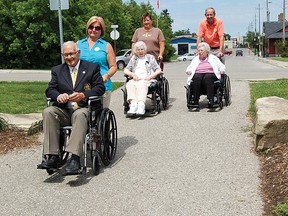 Tillsonburg Mayor John Lessif rides a wheelchair down Veterans Memorial Walkway. KRISTINE JEAN/TILLSONBURG NEWS