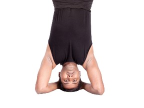Yoga headstand pose in padmasana by Indian man. (Fotolia.com)