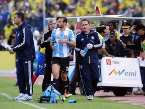 Argentina's football player Javier Mascherano waits to return to the field after he was injured during a FIFA World Cup Brazil 2014 South American qualifier football match against Ecuador in Quito on June 11, 2013. (AFP)