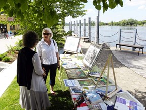 Local artist Frances Luymes and city resident Marianne Crozier chat on Riverfront Square. The latest Quinte West revitalization project, this time on the Trent River, was opened Friday.