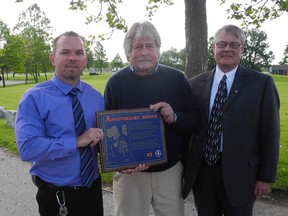 Valley Heights Secondary School principal Mike DeGroote, retired teacher Ross Bateman and Grand Erie District School Board director of education John Forbeck were on hand Friday, June 14, 2013 to unveil a new plaque to honour Anniversary Avenue, the laneway leading up to the school which is lined with native Carolinian trees.  (SARAH DOKTOR Simcoe Reformer)