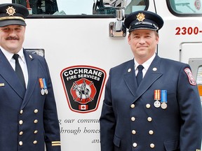 Twenty years of service by Captain Huw Jefferies, left, and Sr. Firefighter Danny Fenton was recognized with the presentation of Fire Exemplary Service medals, June 10.