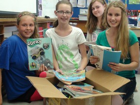 St. Bernard Grade 7 students (from left) Lara Evans, Charlotte Curry, Morgan Goodine and Hailey Harris do some packing on Friday. The school will close at the end of the month and students will transfer to the new St. Pius School on Wood Street. (MICHELLE RUBY Brantford Expositor)