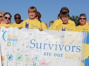 Tyler Linker, centre, leads the Survivors' Lap to kick off Sarnia's 12th annual Relay for Life. Tyler, 12, was diagonosed with leukemia at the age of 3. He is now in remission and volunteers with the Canadian Cancer Society. (LIZ BERNIER, The Observer)