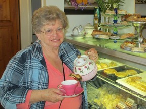 Carol Simone helps to set up a tea display in preparation for the June 18 High Tea to be held at The Cafe, 24 Main St. South in Waterford.