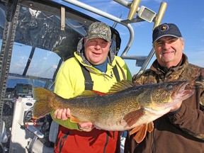 Capt. Joe Pickstock, left, and Ron Campbell with a 15-pound walleye caught and released on the Bay of Quinte in December 2012. (Ashley Rae/For The Whig-Standard)