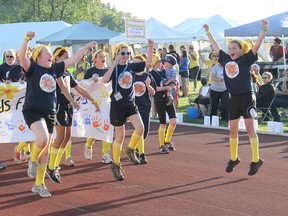 The Kids for a Cure team celebrate their introduction during the Relay for Life fundraiser for the Chatham chapter of the Canadian Cancer Society on Friday, June 14, 2013, at the Chatham-Kent Community Athletic Complex in Chatham, ON. (ELLWOOD SHREVE, Chatham Daily News)