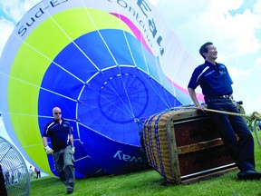 Scott MacRitchie, left, and Ontario Tourism Minister Michael Chan stand by the Great Waterway hot air balloon after the minister spoke at Reynolds Park in downtown Brockville Friday. THOMAS LEE The Recorder and Times