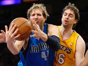 Dallas Mavericks' Dirk Nowitzki (L) of Germany and Los Angeles Lakers' Pau Gasol of Spain battle for a rebound during the second half of their NBA basketball game in Los Angeles April 2, 2013. (REUTERS)