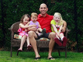 Brad Burleau poses for a photo with his children at his home in Otrleans, On. Friday June 13, 2013. Sitting with thier dad is Cadence, Emersyn and Madison. Tony Caldwell/Ottawa Sun/QMI Agency