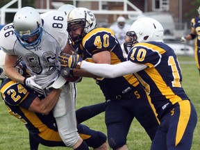 Ben Leeson/The Sudbury Star
Sudbury Spartans' Mitch Nyssen (86) is tackled by Sault Steelers' Michael Hope (24), Matt Gauthier (40) and Frank Weise (10) during Northern Football Conference action at Queen's Athletic Field in Sudbury on Saturday night.