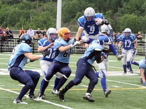 Ben Leeson/The Sudbury Star
Sudbury Gladiators' Austin Kirkey goes airborne while trying to avoid a group of Toronto Junior Argos defenders during Ontario Football Conference varsity action at James Jerome Sports Complex on Saturday.