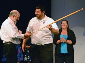 Valley Heights teacher Dave Zakel presents retiring VHSS teacher and coach Larry Wiebe (left) with a commemorative canoe paddle thanking him for his many years of coaching rowing and cross-country. CHRIS ABBOTT/TILLSONBURG NEWS/QMI AGENCY
