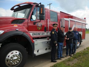 County of Grande Prairie Fire Service Fire Chief Everett Cooke (left), division councillor Ross Sutherland. Wembley Mayor Chris Turnmire and Wembley Fire Chief Richard Querin stand in front of the Wembley’s brand new fire truck, which was donated by the county, Saturday. (Aaron HInks/Daily Herald-Tribune)