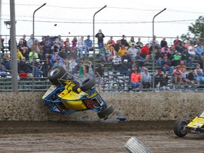 Nick Landon (82) of Dorr, Mich., flips during a Can-Am Topless Sprint heat race after touching tires with Tilbury's Kyle Patrick on Saturday at South Buxton Raceway. Landon wasn't hurt but he was done for the night. (JAMES MACDONALD/Special to The Daily News)