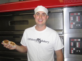 Justin Niklaus holding two of Offshore Bakery’s famous butter tarts.