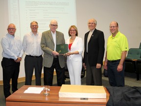 John Dahl, president of the Heritage Society and chair of the history book committee, presents town council with a copy of Whitecourt A History 1975-2010 at the Forest Interpretive Centre on June 10, after working on the project for eight years.
Johnna Ruocco | Whitecourt Star