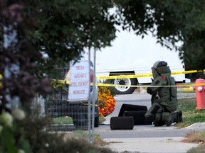 An officer from the RCMP's Explosive Disposal Unit in Edmonton examines a suspicious package in this 2009 photo. Members of the team assisted local police after explosives were found in a Gregoire trailer park.