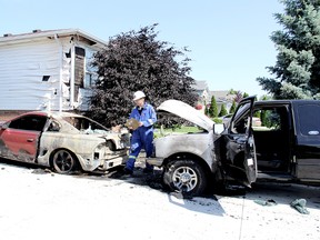 Chatham-Kent fire inspector Guy Deschenes notes damage to a 1994 Mustang GT and a 2011 Ford Ranger destroyed by fire in the owner's driveway at 13 Massey Drive in Tilbury, Ontario on Monday June 17, 2013. The cause of the fire remains under investigation. A neighbour's house was also damaged.

VICKI GOUGH/ THE CHATHAM DAILY NEWS/ QMI AGENCY