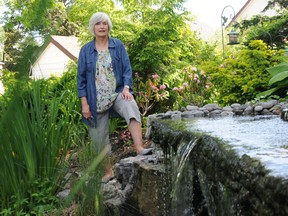 Lee Casselman, co-convenor for the annual garden tour, stands near a fountain in a garden at a home on Albert Street. The tour, operating for 14 years, serves as a fundraiser for the Canadian Federation of University Women Belleville and District's bursary program.