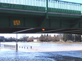 Rising water covers the roadway under Fifth Street Bridge. (QMI Agency file photo)